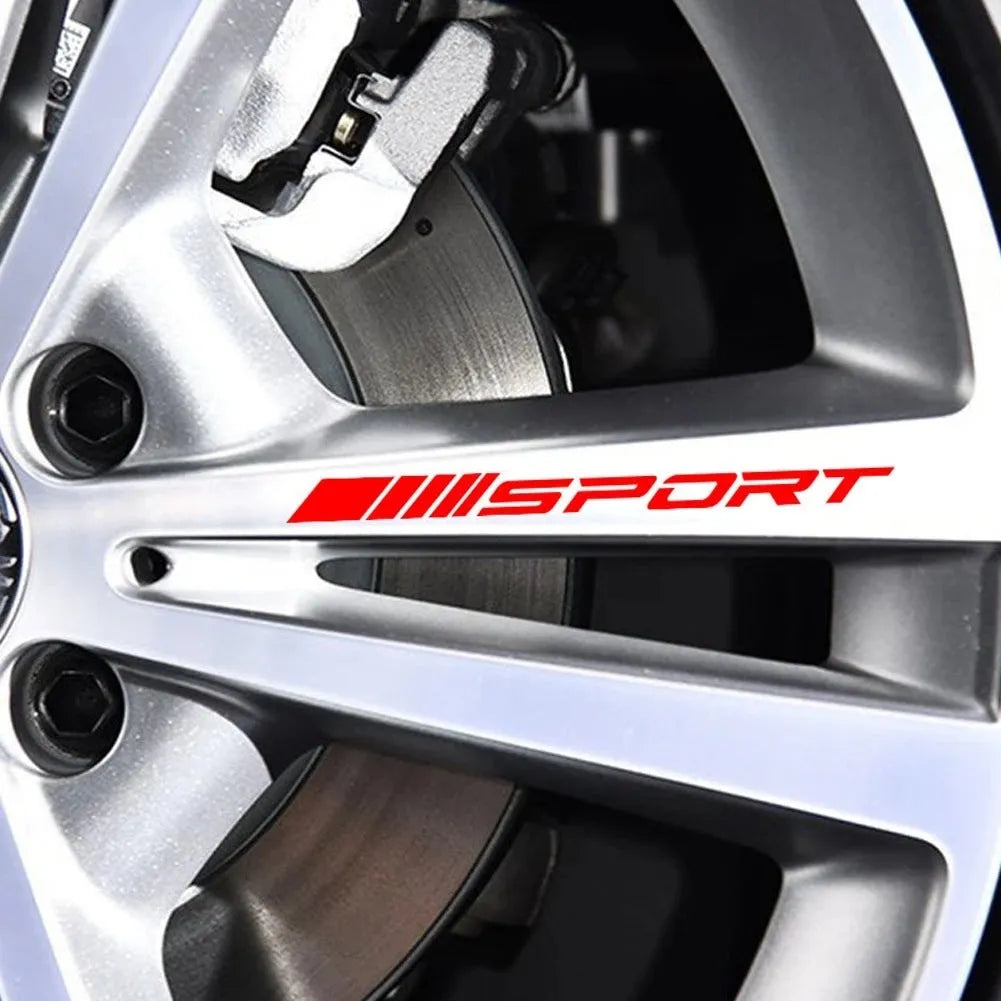 Black hollow design sports car rim sticker measuring 10cm by 0.7cm on an alloy wheel.