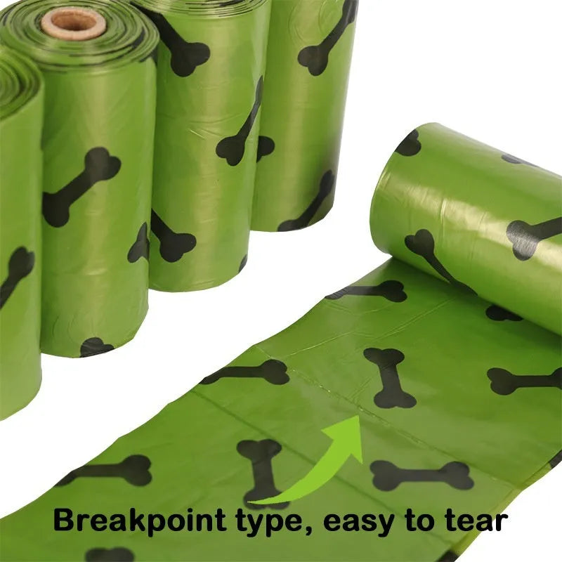 Roll of army green degradable dog waste bags with black bone print, 23cm by 33cm size.