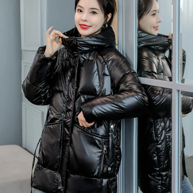 A loose-fitting, hooded winter jacket for women in a thick acrylic blend fabric, shown on a hanger.