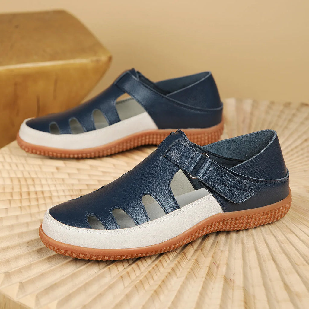 Women's plus size flat sandals with hollow out toe cap in blue, red, or white on thick rubber sole.