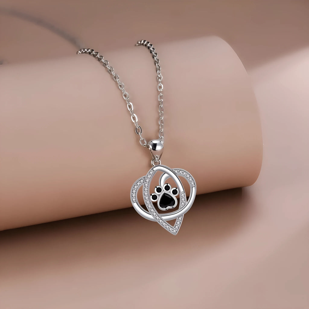 Copper necklace with dog paw and cat footprint pendant on a cross chain.