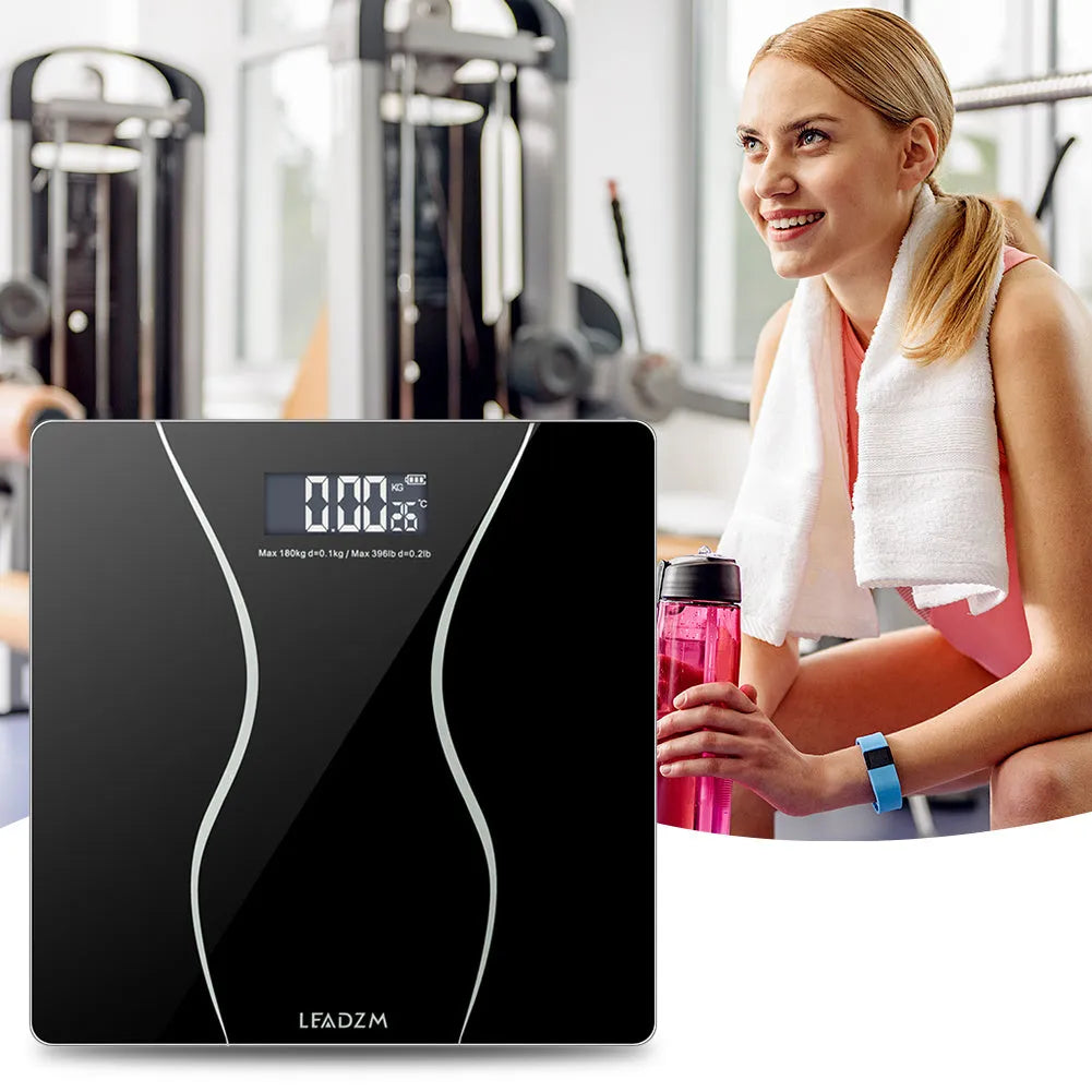 Black electronic bathroom scales with digital display showing weight measurement up to 180 kg capacity