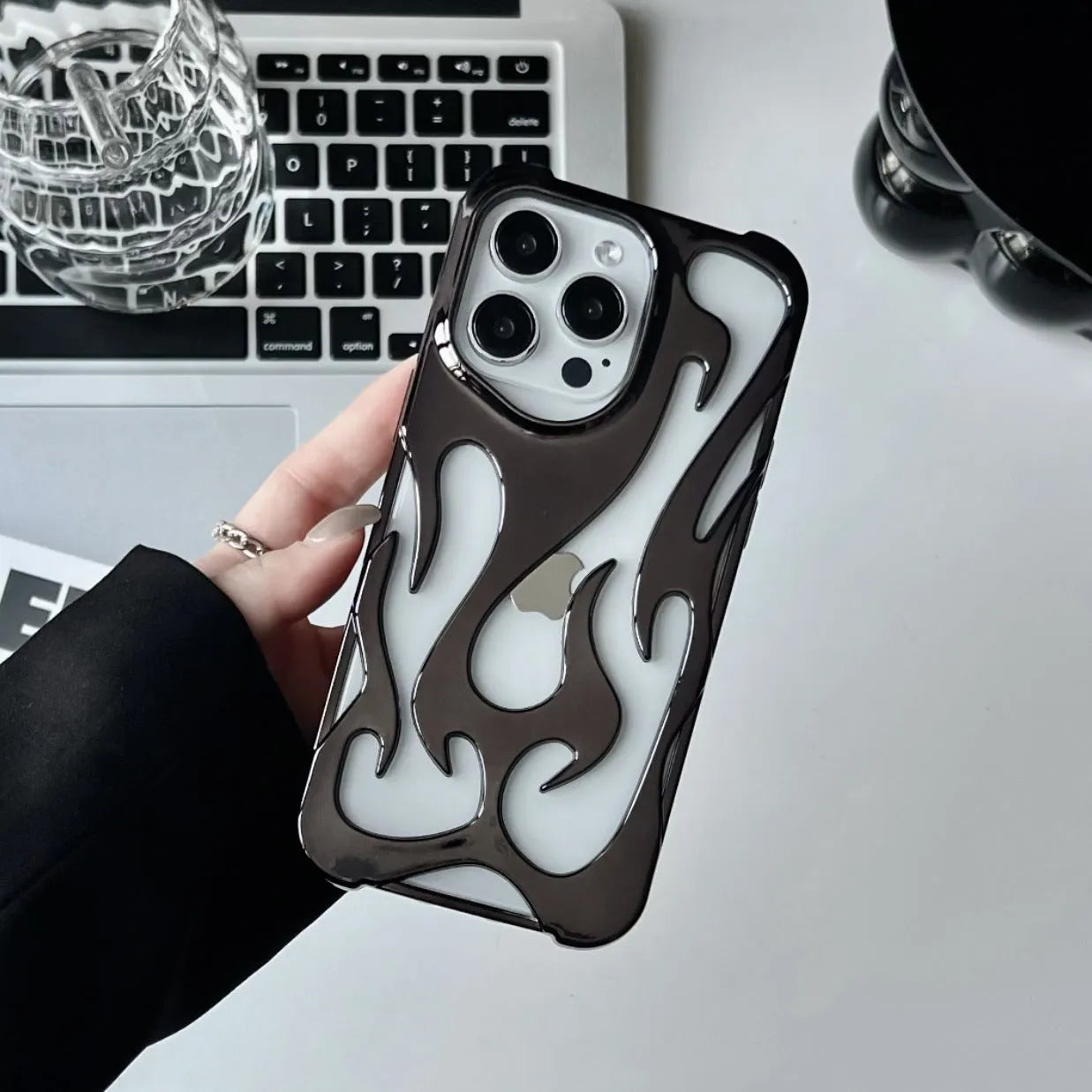 Electroplated hollow flame pattern design on a soft TPU iPhone case, shown in a silver finish.