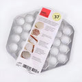 Creative dumpling mold with 37 holes made from aluminium alloy on a kitchen counter