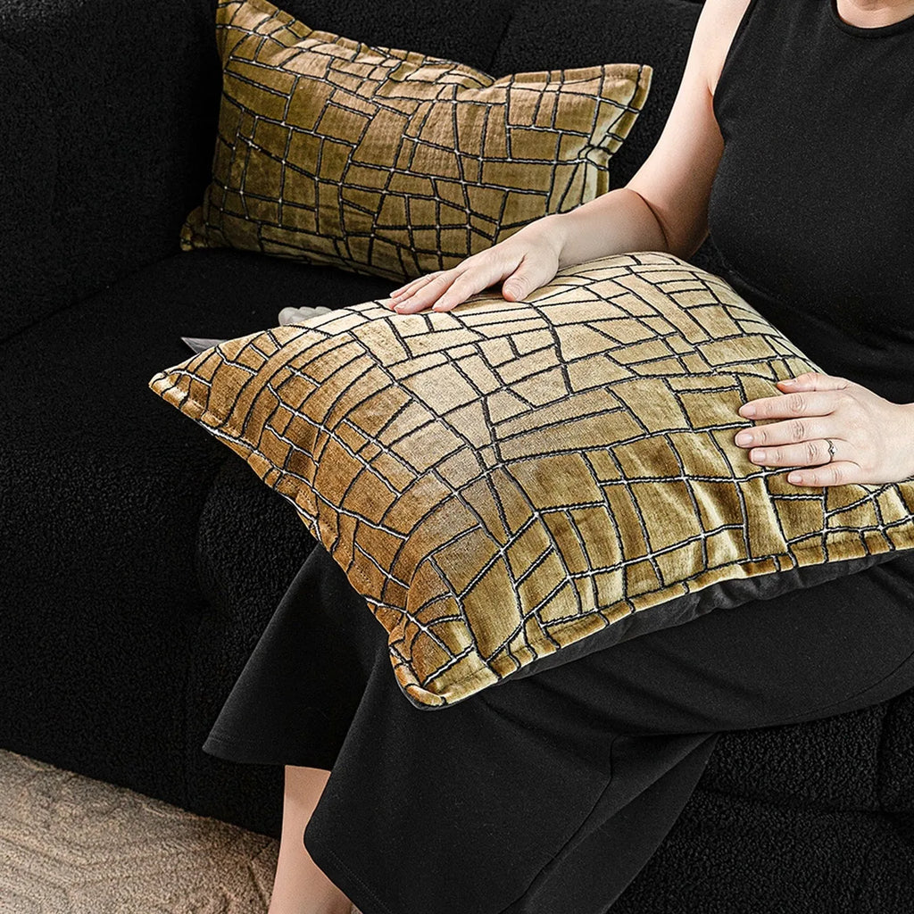 Gold geometric abstract pattern on a square polyester cushion cover with feather velvet pillow insert.
