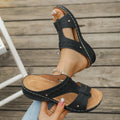 Blue casual slippers with a fish mouth toe holder and slope heel on a wooden floor.