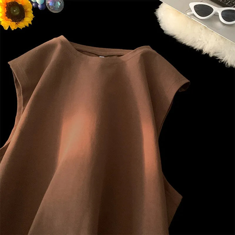 Men's solid colour loose sleeveless cotton tank top on a hanger, shown in apricot colour.