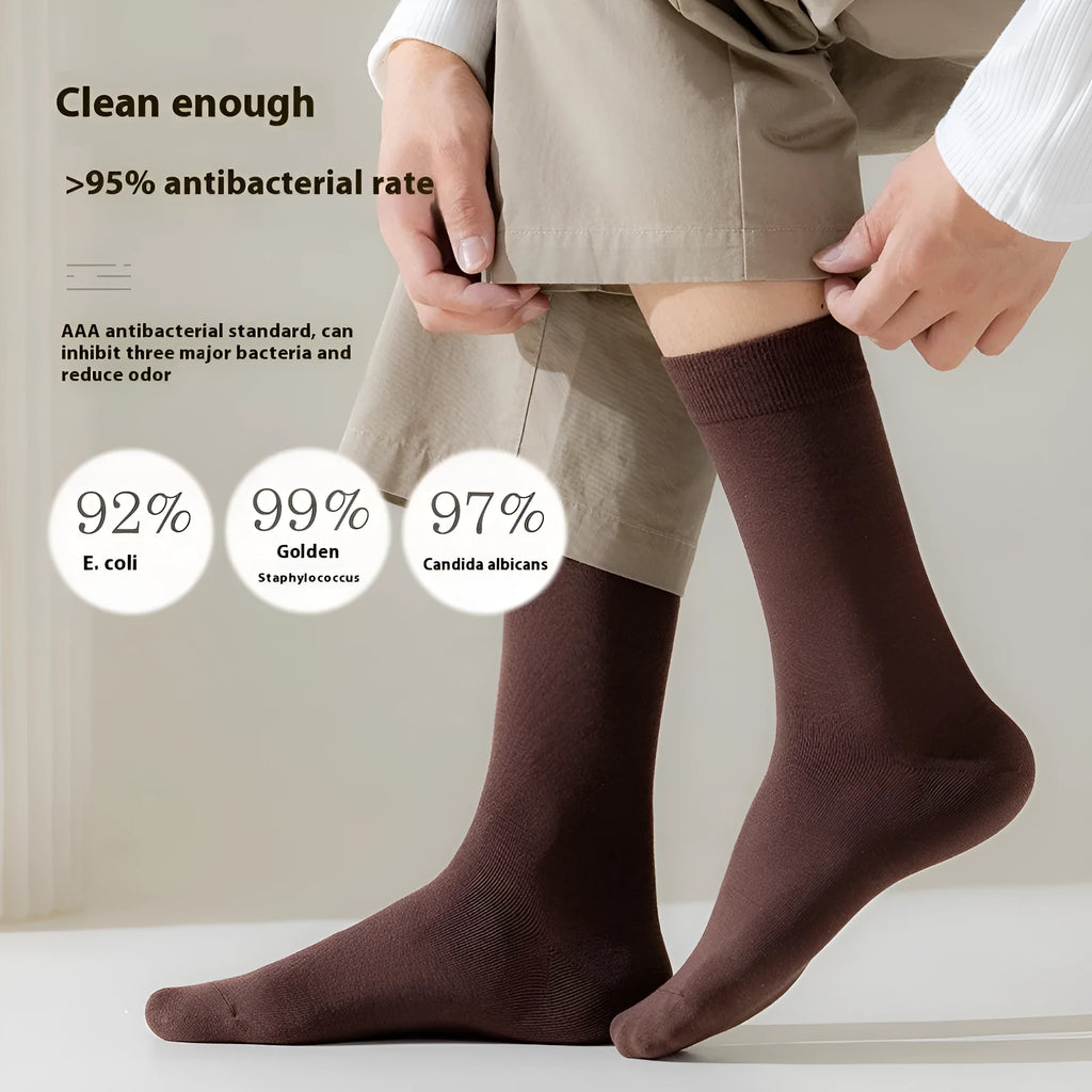 A pair of men's solid colour mid-calf socks made from combed cotton for business wear.