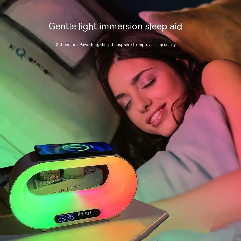 White 3-in-1 LED night light with wireless charger and alarm clock on a bedside table, 23.8cm tall