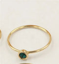 Women's 14K gilded copper knuckle ring with green cubic zirconia stone in US size 7.