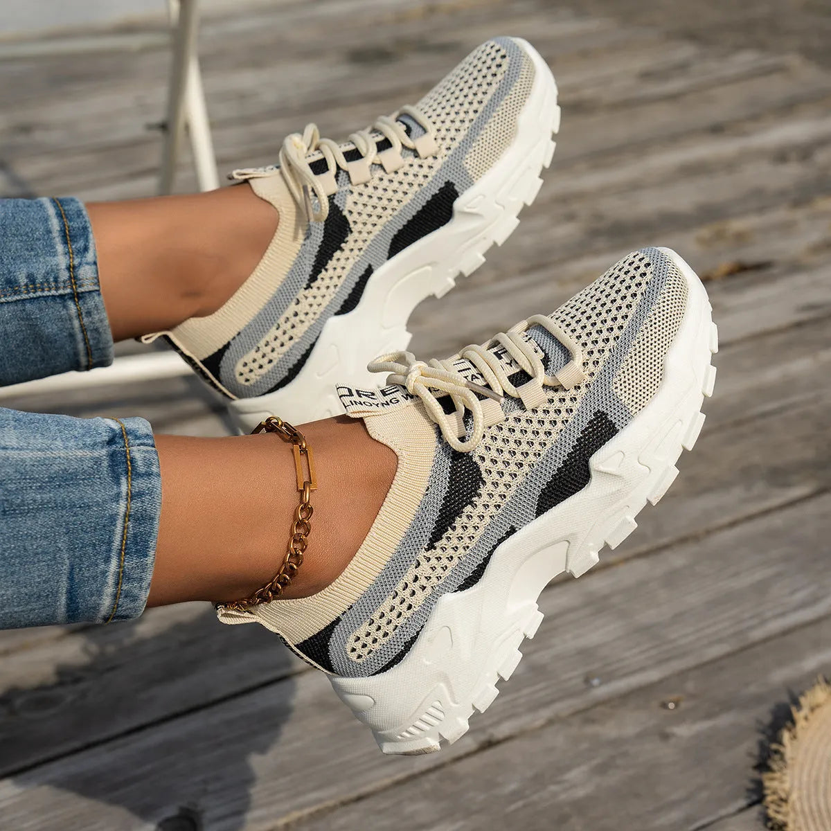 Women's Flyknit mesh lace-up sneakers in a multi-tone colourway with a low rubber sole.