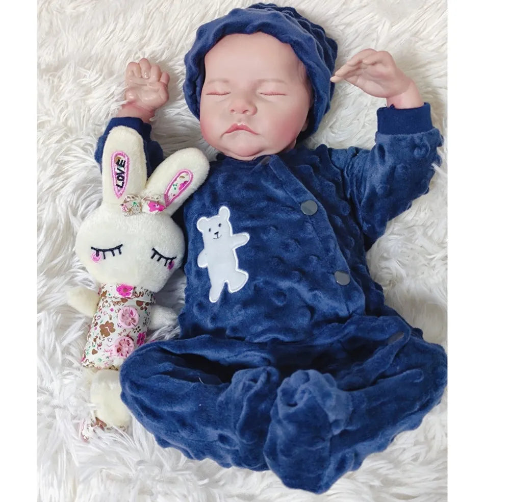 18-inch reborn doll with cloth body in soft pink romper sitting on table