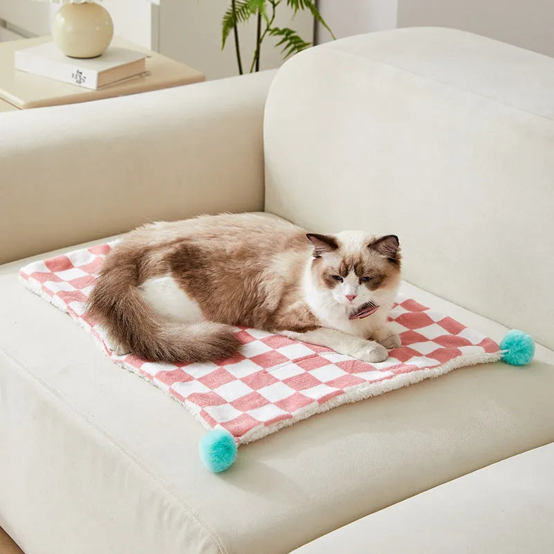 Plaid pattern pet blanket with fur ball decoration in green, pink, or yellow colours on soft fleece material