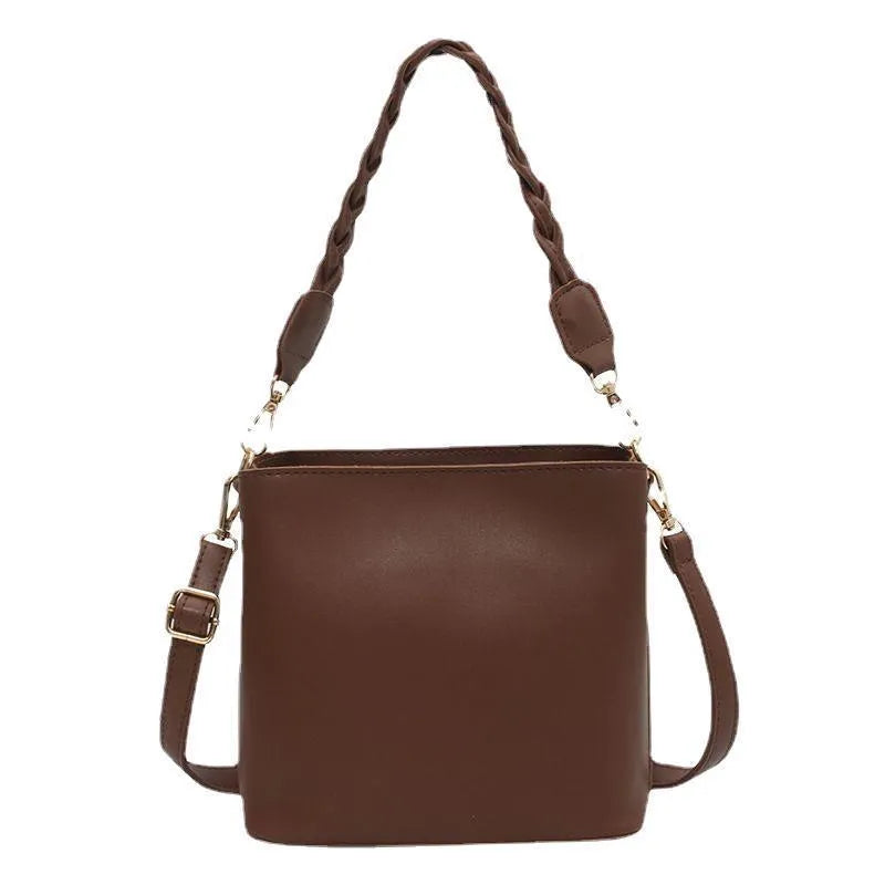 Retro brown bucket bag with weaving pattern, showing crossbody strap and underarm design