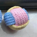 Four handmade plush cotton ball cat toys in blue powder, green blue, and pink green colours for teeth grinding play