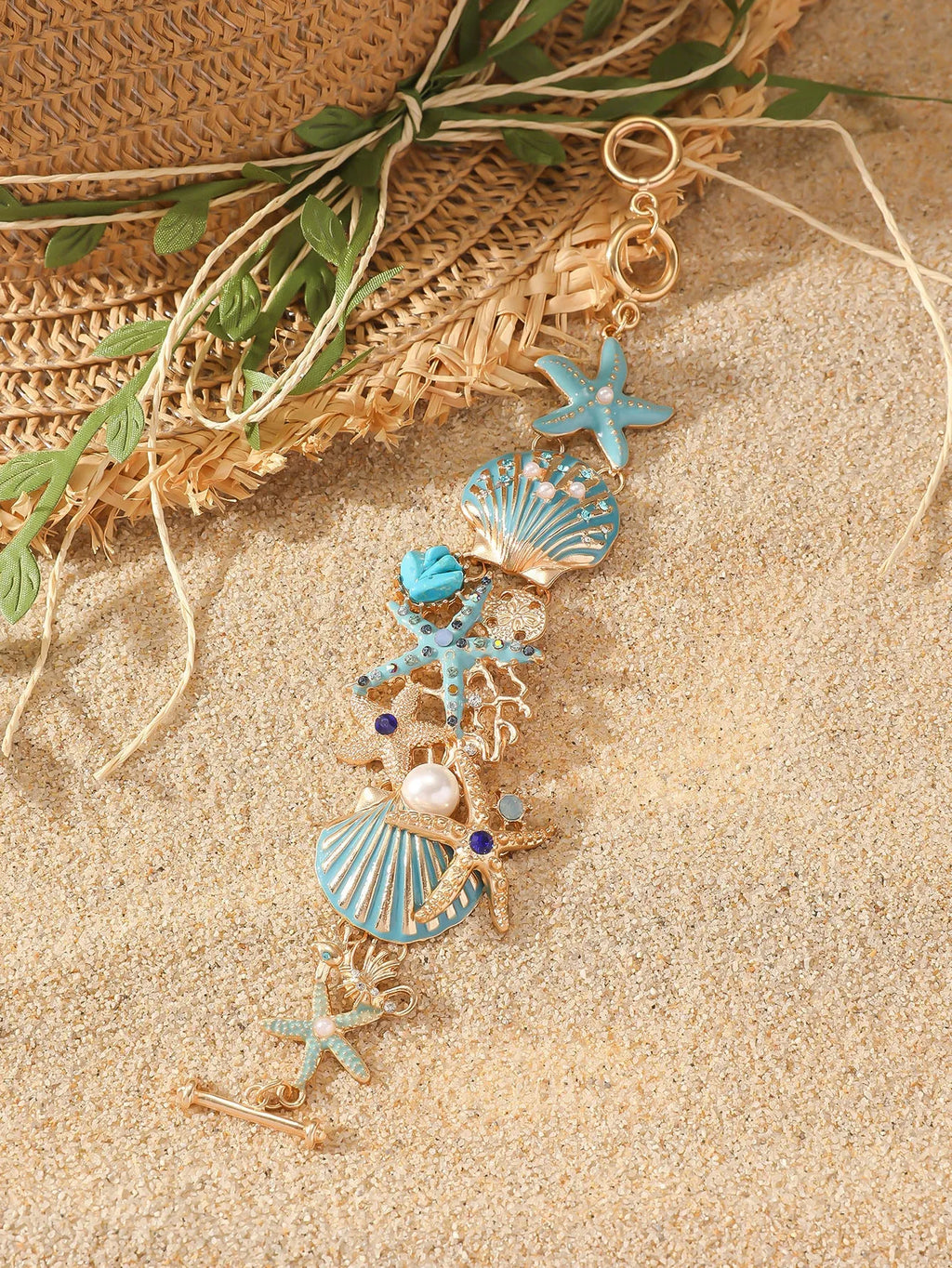 Women's alloy bracelet with starfish and boat anchor rhinestones in turquoise, red, or blue.