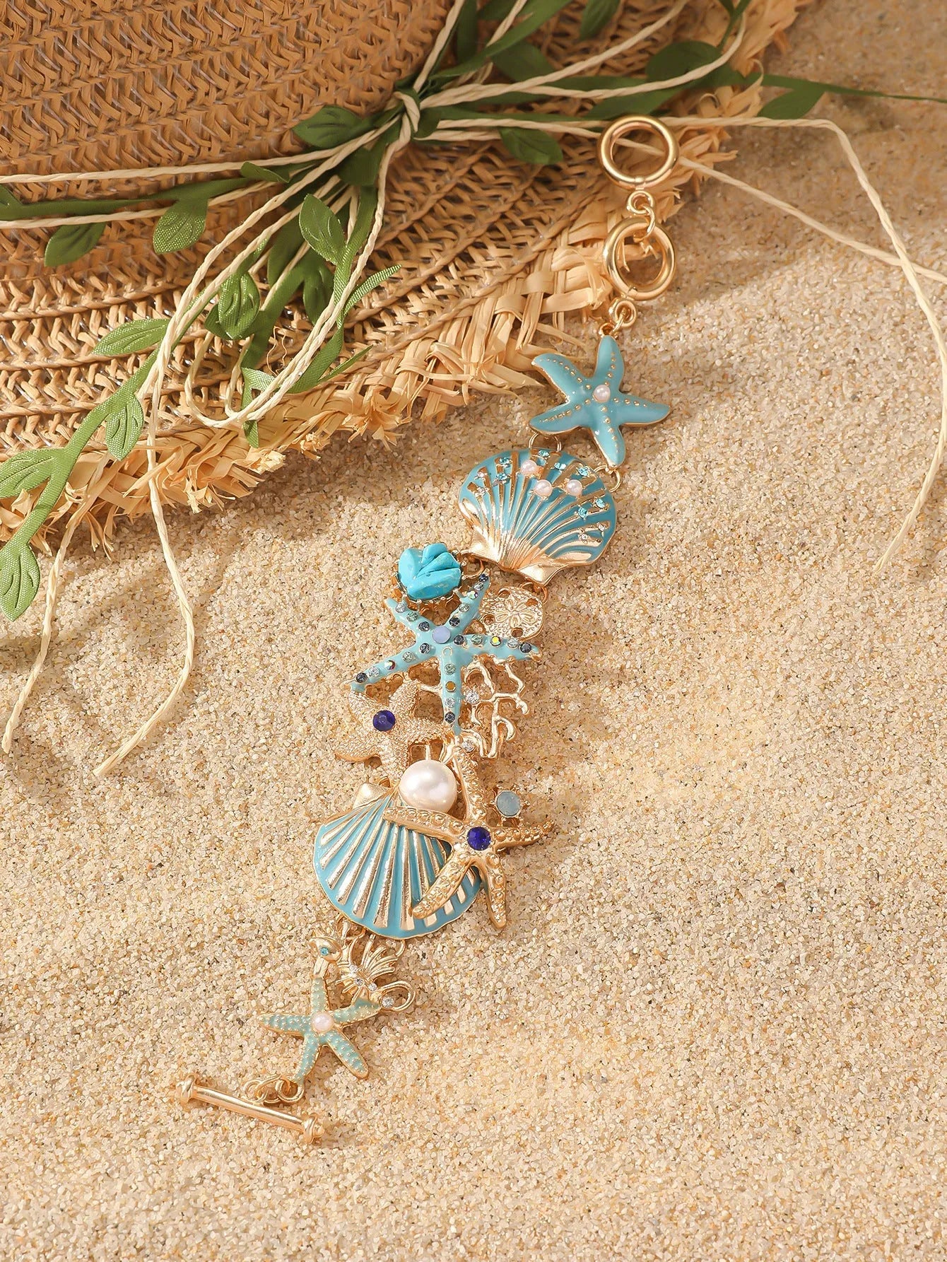 Women's alloy bracelet with starfish and boat anchor rhinestones in turquoise, red, or blue.