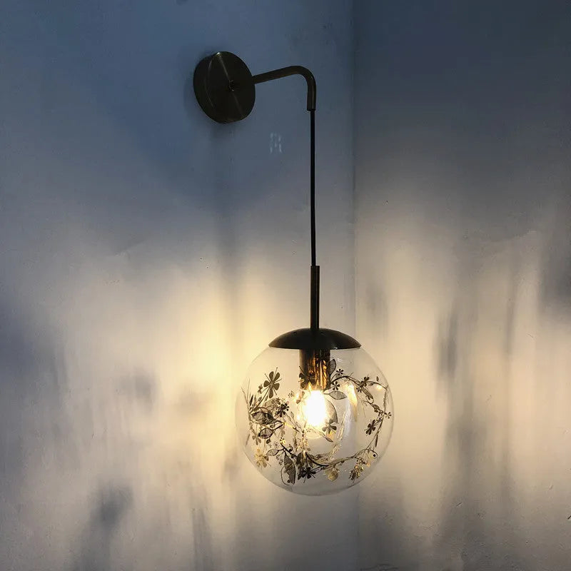Modern glass wall lamp with minimalist design shown in bedroom setting