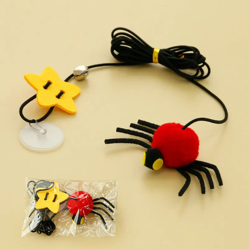 Red and yellow hanging door cat toy with elastic rope, feather, bell, and spider attachments.