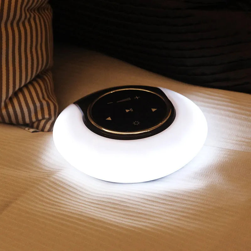 Creative folding Bluetooth speaker and LED desk lamp with touch controls on a desk.