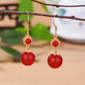 Geometric southern red agate and silver-inlaid jasper earrings with copper alloy posts.