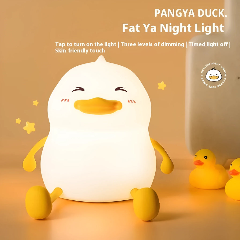 Chubby Night Light silicone desk lamp and mobile phone holder on a wooden surface.