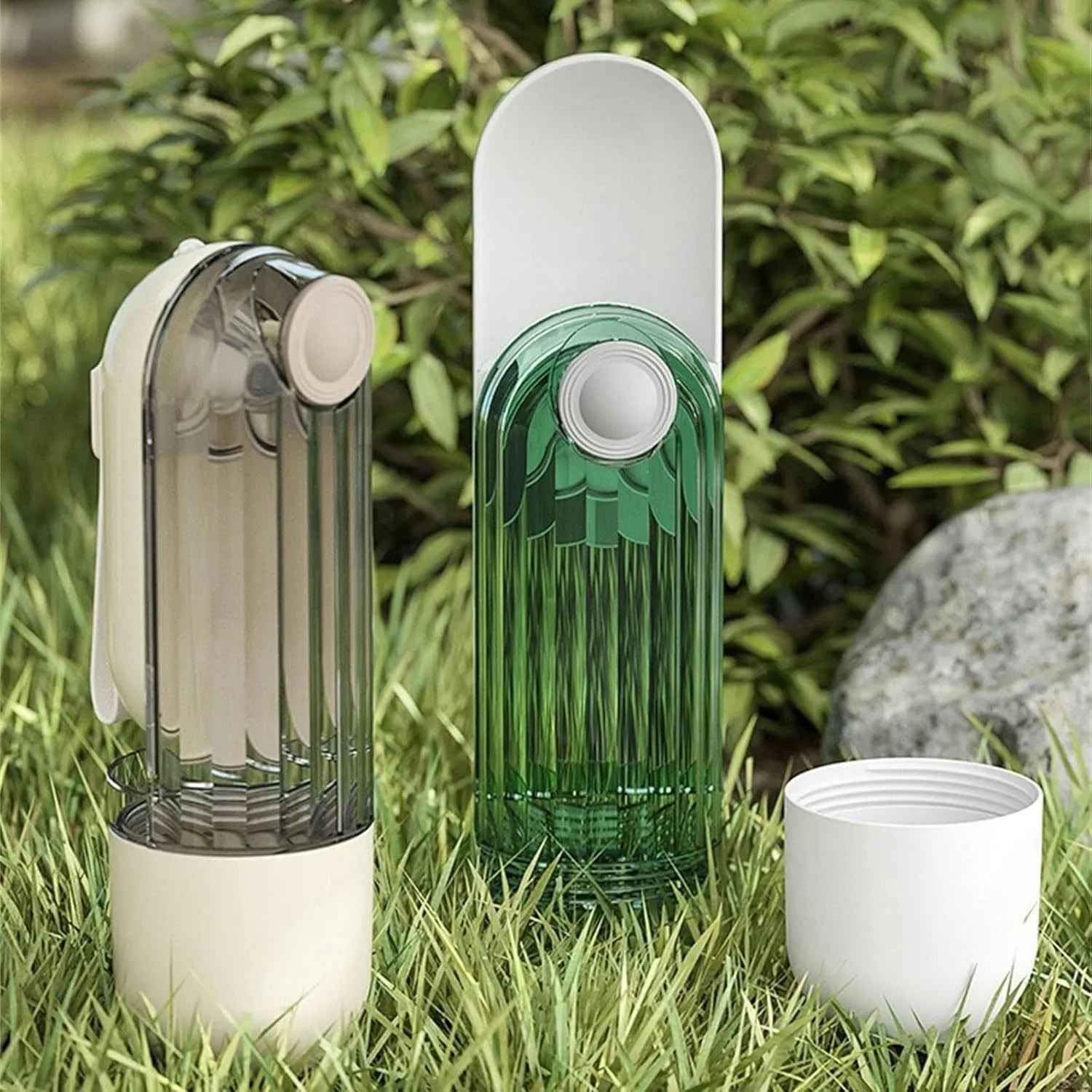 Green foldable dog water bottle with leak-proof lid and food container, shown extended for use.