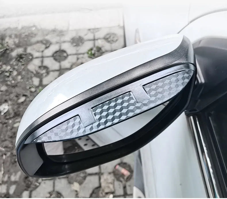 Pair of Mazda reversing mirror rain barrier strips in carbon fibre pattern on a Mazda CX5 side mirror