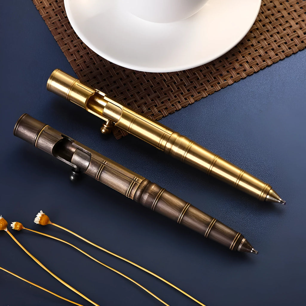 Solid brass bolt-action tactical pen with machine gun design on a dark surface.