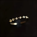 Gold coloured open mouth ring with copper base and zircon detail on white background