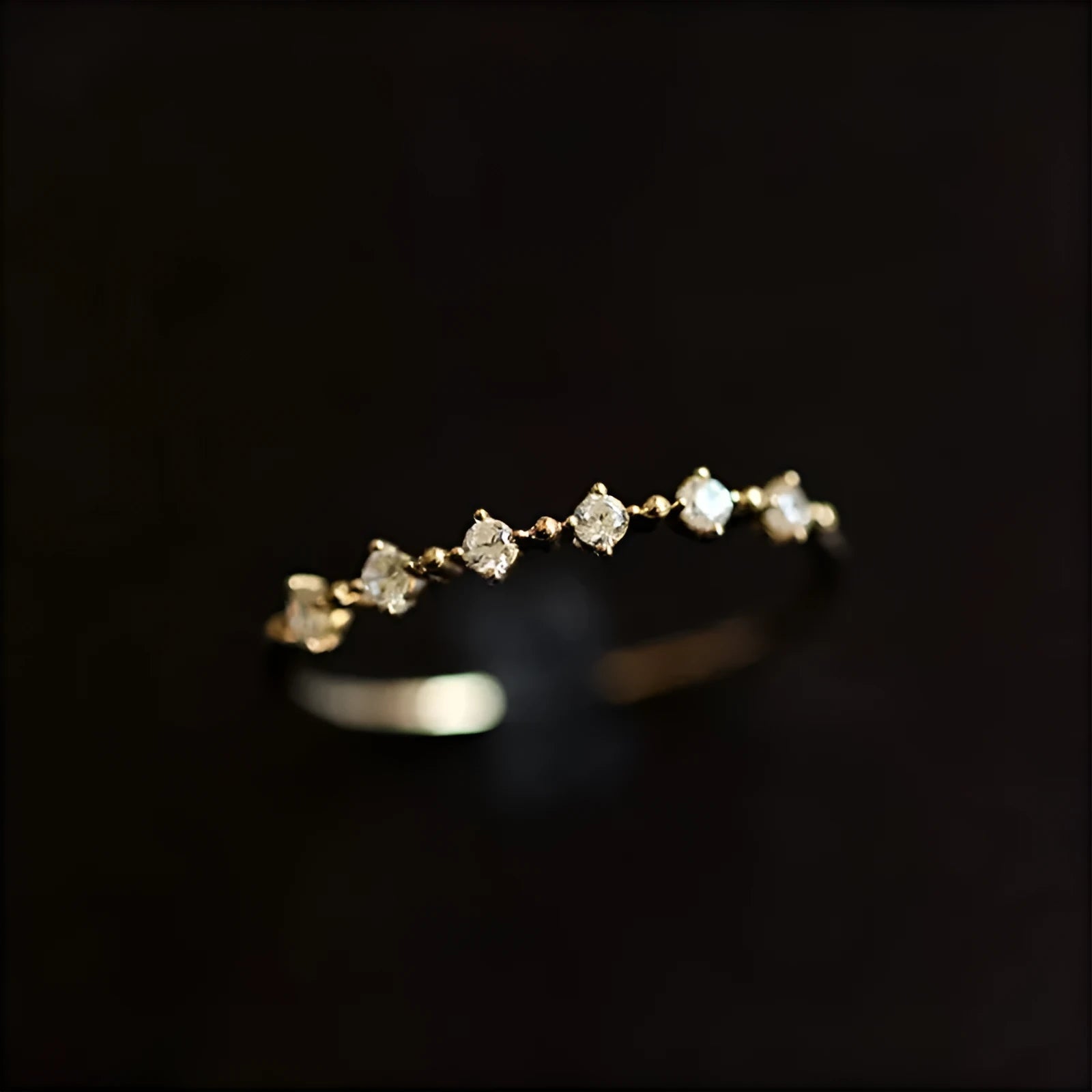 Gold coloured open mouth ring with copper base and zircon detail on white background