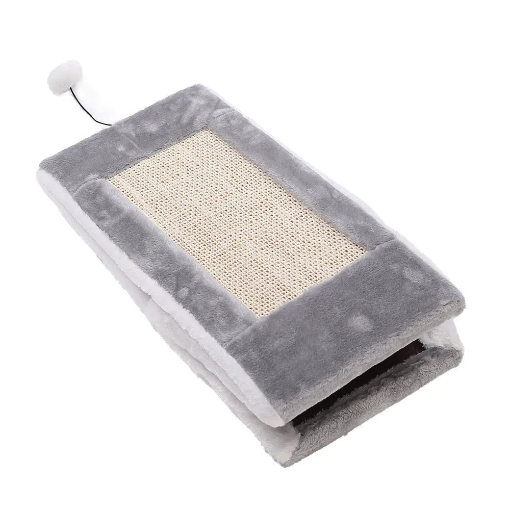 Grey and white triangular cat scratching post and bed with sisal fabric sides and a soft plush platform.