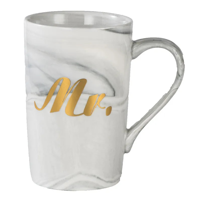 Light luxury ceramic cup gift box set with pink mug, candy, and towel on display