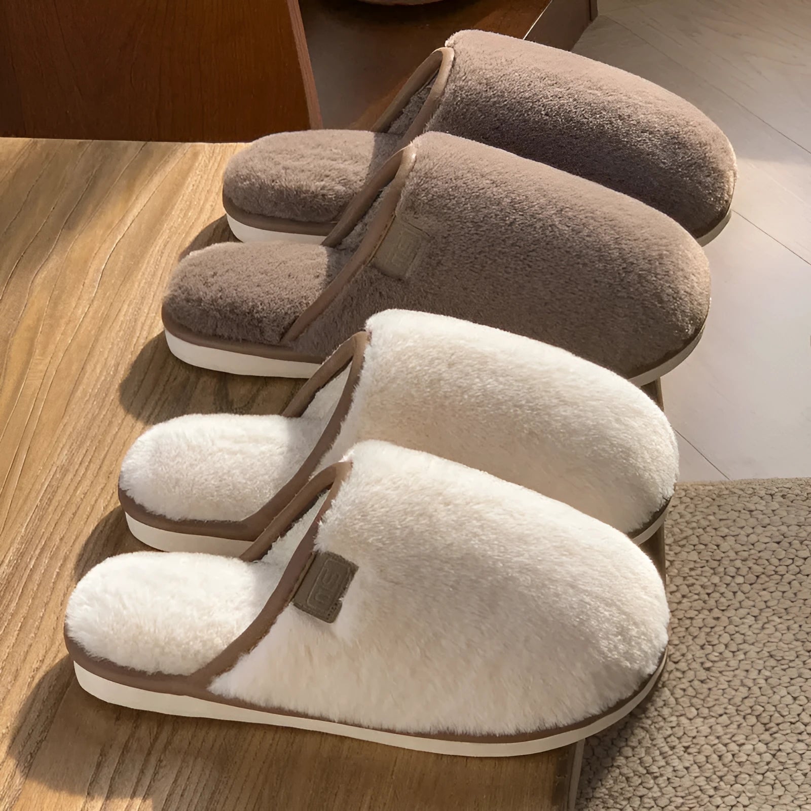 Pair of solid blue plush winter slippers with non-slip PVC sole on a wooden floor.