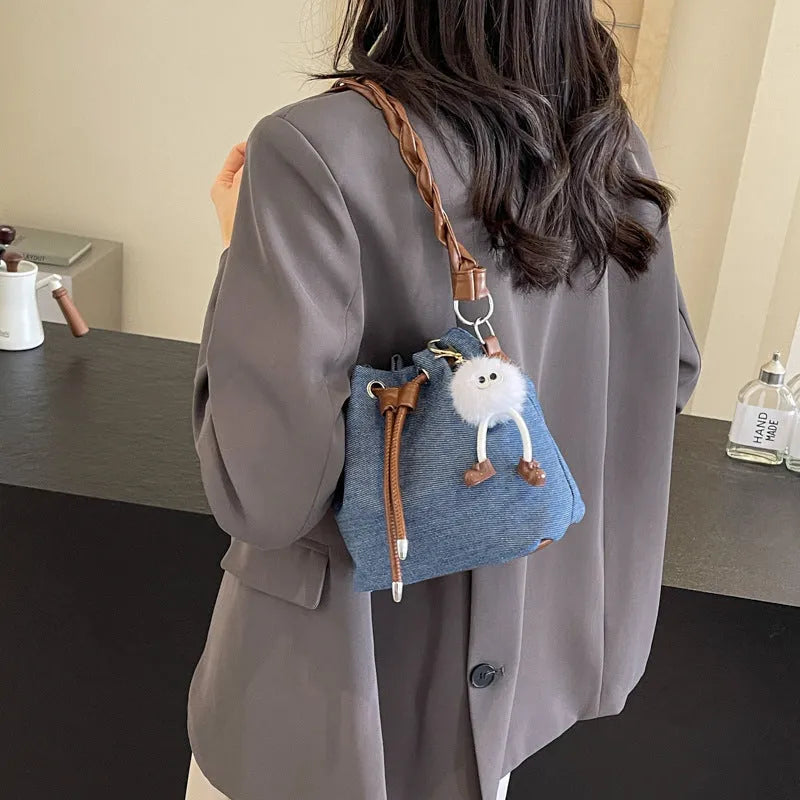 Blue one-shoulder cross body bucket bag with sandwich pocket and synthetic leather lining