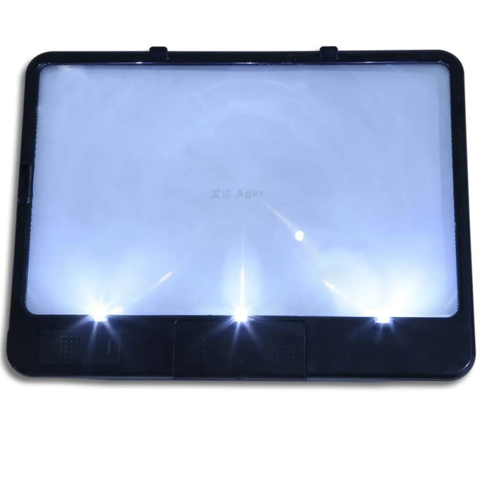 Black and white LED magnifying glass with 3x lens on a desktop next to a book.