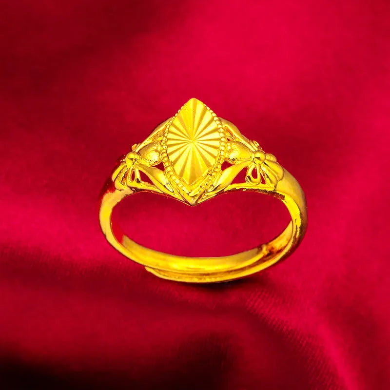 Gold coloured electroplated brass ring with a geometric open diamond flower design and textured details.
