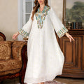 White long sleeve Arabic robe for women, Dubai style, with full-length skirt.