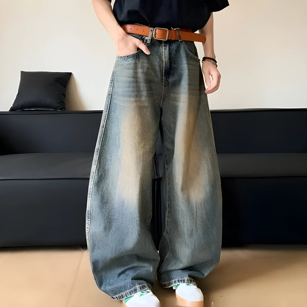 Retro blue distressed machete denim jeans for men with a wide-leg slim cut.