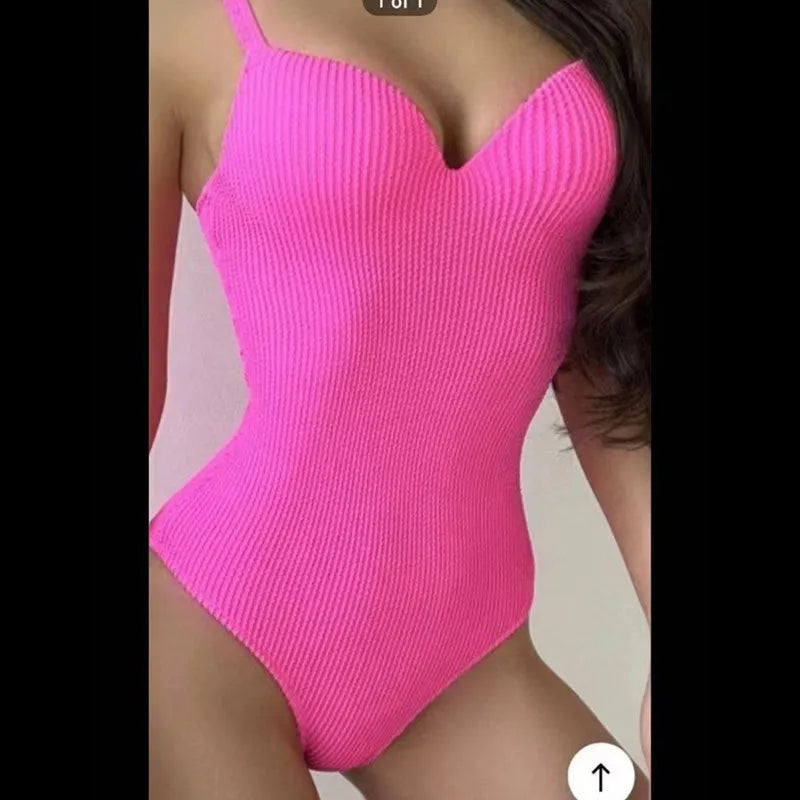 Women's black one-piece swimsuit with sunken stripe design and sleeveless cut on a mannequin.