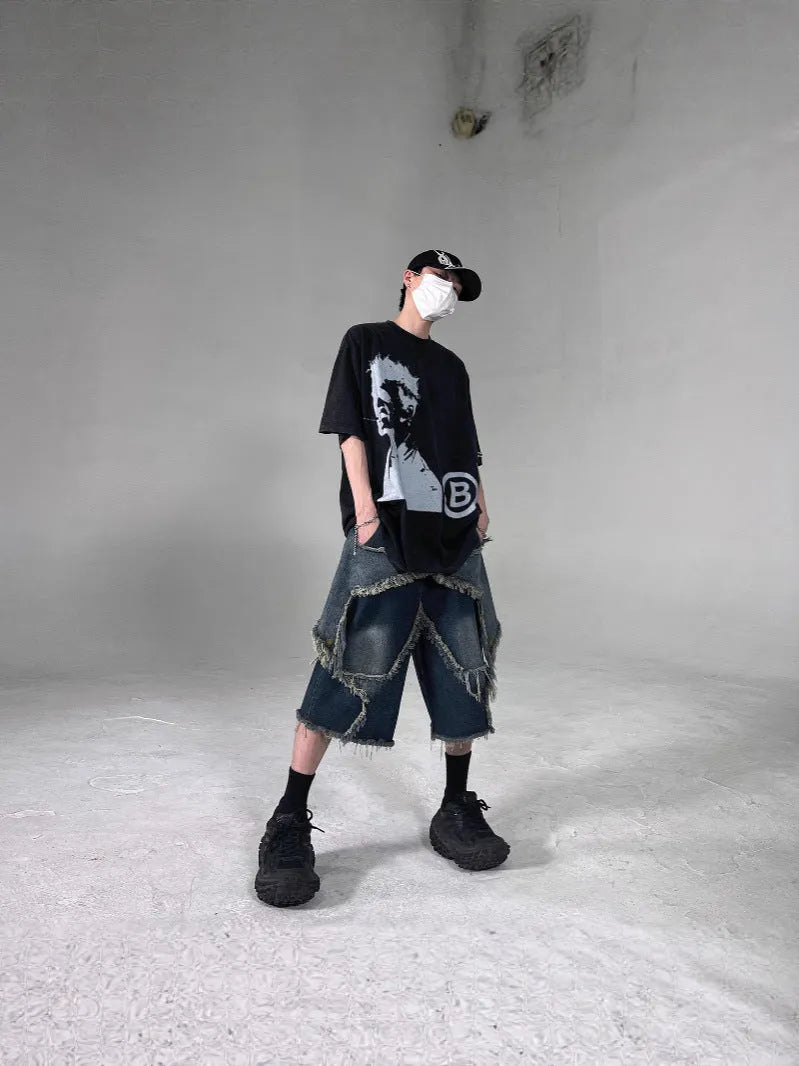 Blue men's loose-fit denim shorts with a frayed five-pointed star detail on the leg, showing American retro style.
