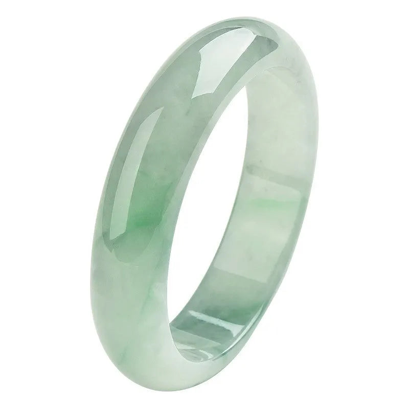 Light green jade bracelet on a white background, showing natural stone texture.