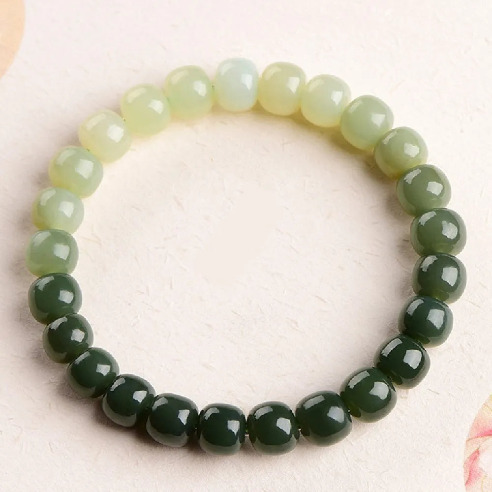 Natural Hetian jade bracelet showing a sunny water gradient colour on polished beads.