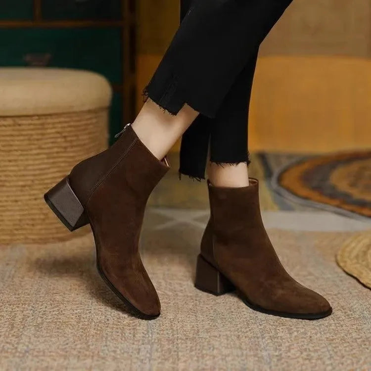 Women's suede martin boots in black with block heel and back zipper on a white background