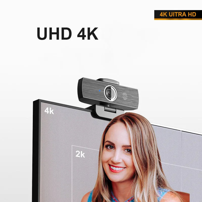 Black 4K USB webcam on a desktop with a magnetic privacy cover next to it