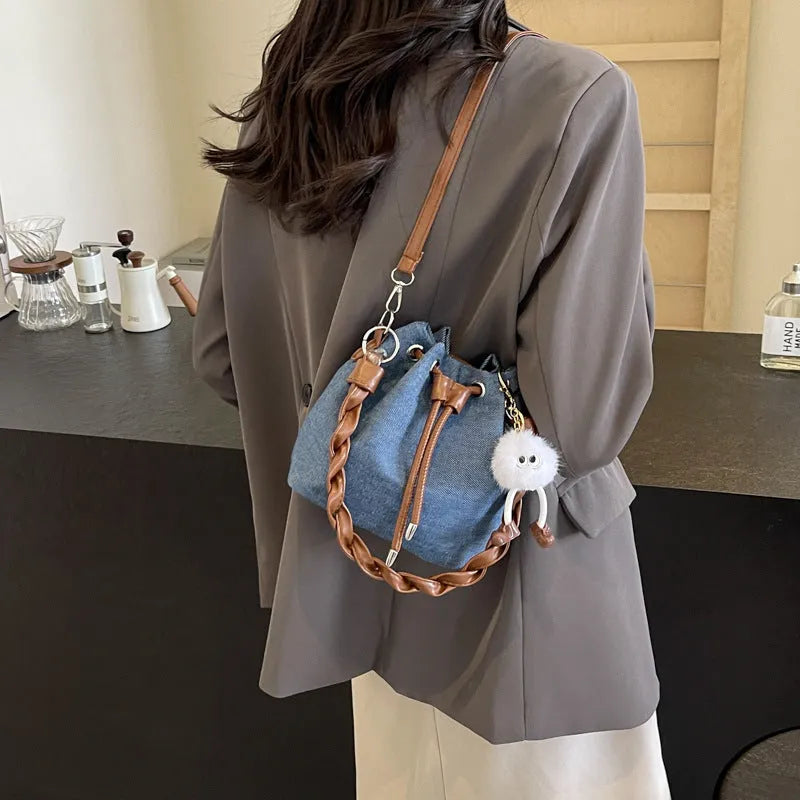 Blue one-shoulder cross body bucket bag with sandwich pocket and synthetic leather lining