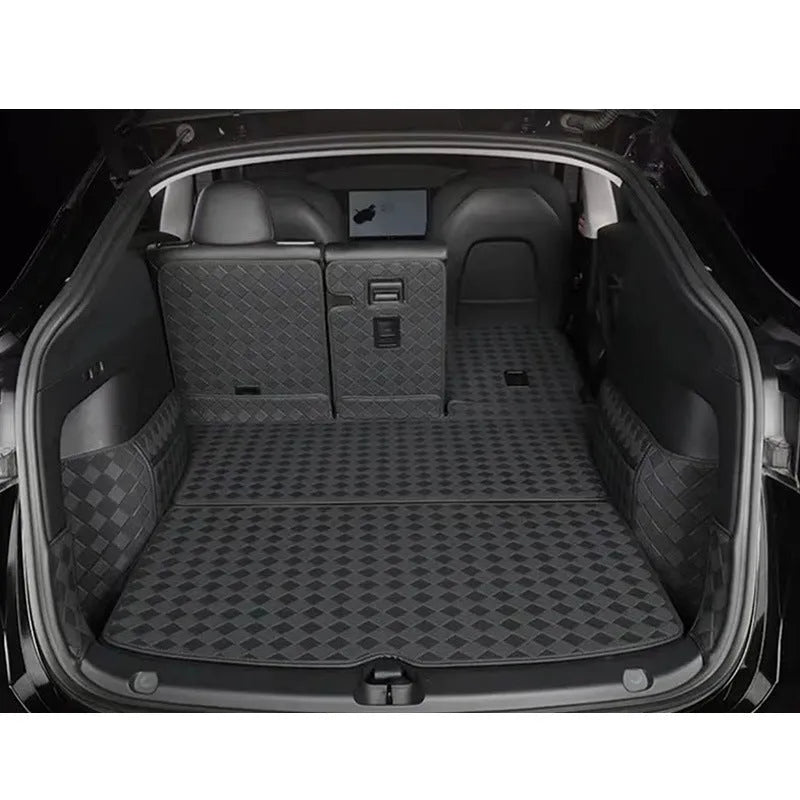 Black leather boot liner mat fitted in the luggage compartment of a Tesla Model Y