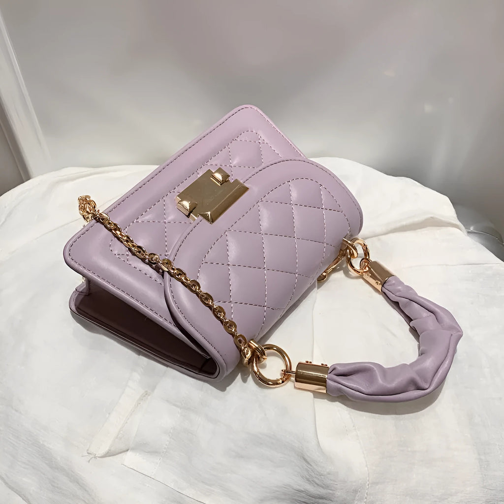 A purple PU leather small square women's crossbody bag with a chain detail and a long strap.