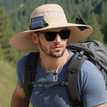 Man wearing a beige solar-powered fan hat with a neck flap outdoors.
