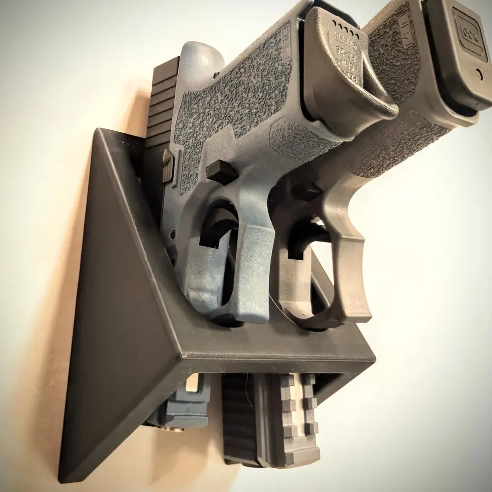 Black plastic pistol stand gun holder measuring 10.85cm x 7.6cm for displaying replica firearms